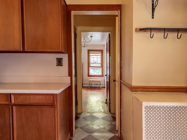 a view of a hallway with wooden floor and a hallway