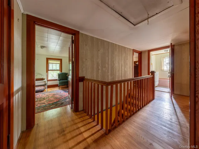 a view of a room with wooden floor