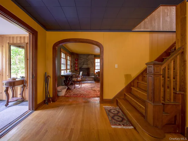 a view of entryway and hall with wooden floor