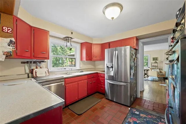 a kitchen with stainless steel appliances granite countertop a refrigerator and a sink