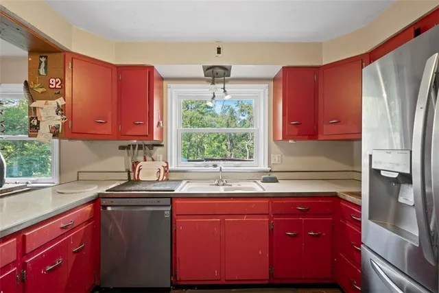 a kitchen with a sink a refrigerator and window