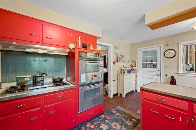 a kitchen with stainless steel appliances granite countertop a refrigerator and a stove top oven