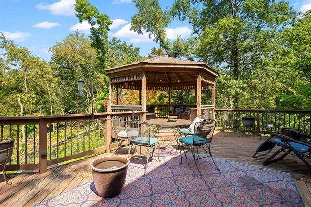 a view of a chair and tables under an umbrella