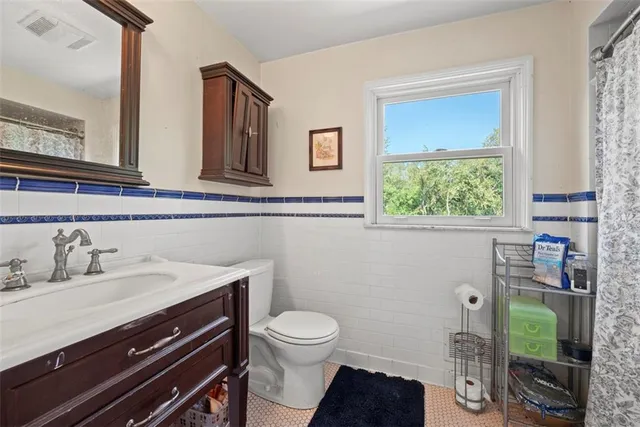 a bathroom with a toilet sink and mirror