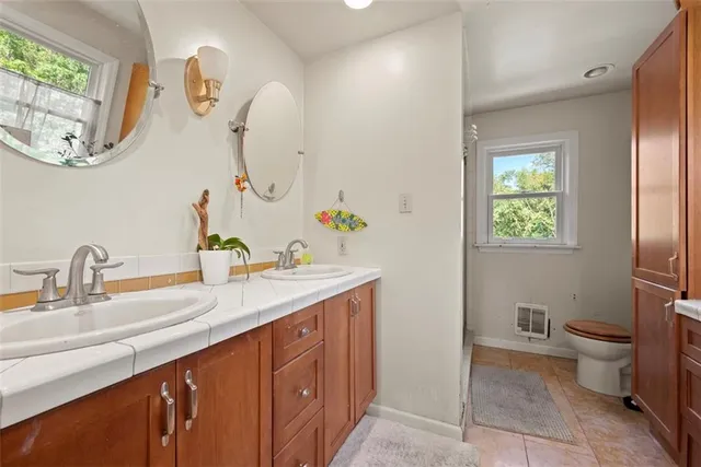 a bathroom with a double vanity sink and a mirror