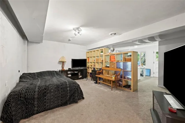 a bedroom with furniture and a flat screen tv