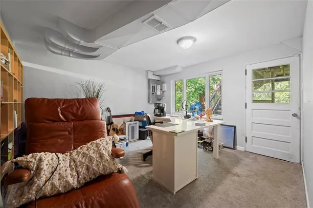 a living room with furniture a large window and chairs