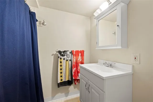 a bathroom with a sink vanity and a mirror