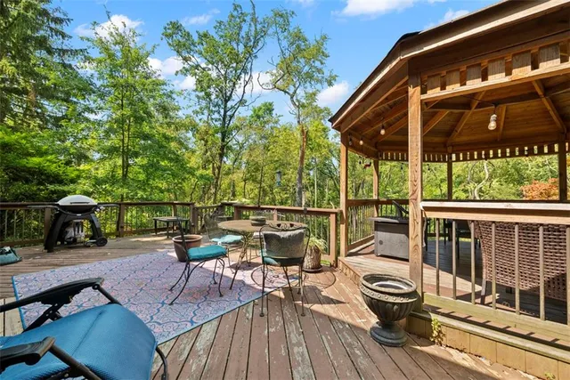 a view of a patio with table and chairs and wooden floor