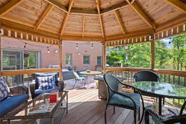 a roof deck with table and chairs and wooden floor