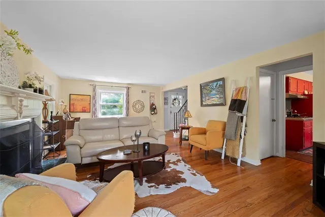 a living room with furniture a flat screen tv and a window