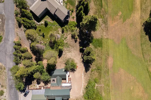 an aerial view of a house with a yard
