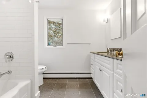 a bathroom with a bathtub sink and toilet