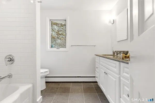 a bathroom with a bathtub sink and toilet