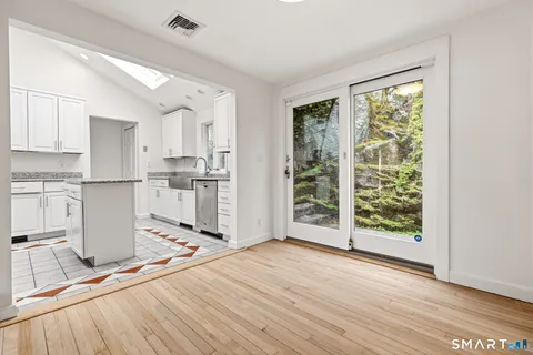 a kitchen with stainless steel appliances a stove top oven and a refrigerator