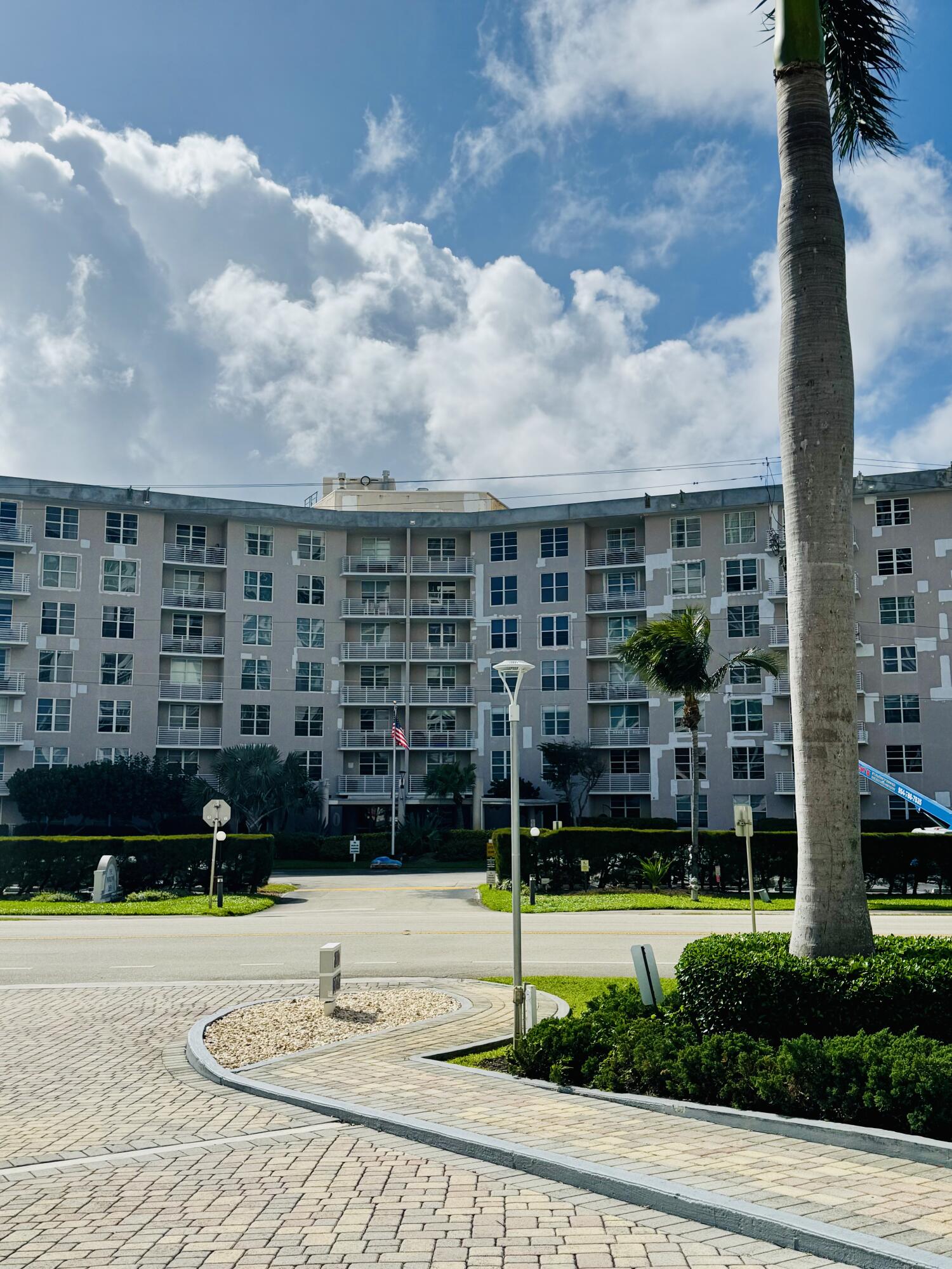 2851 South Ocean Boulevard, Unit 122 Boca Raton, FL 33432 - Photo 1 of 15 a view of a tall building next to a yard