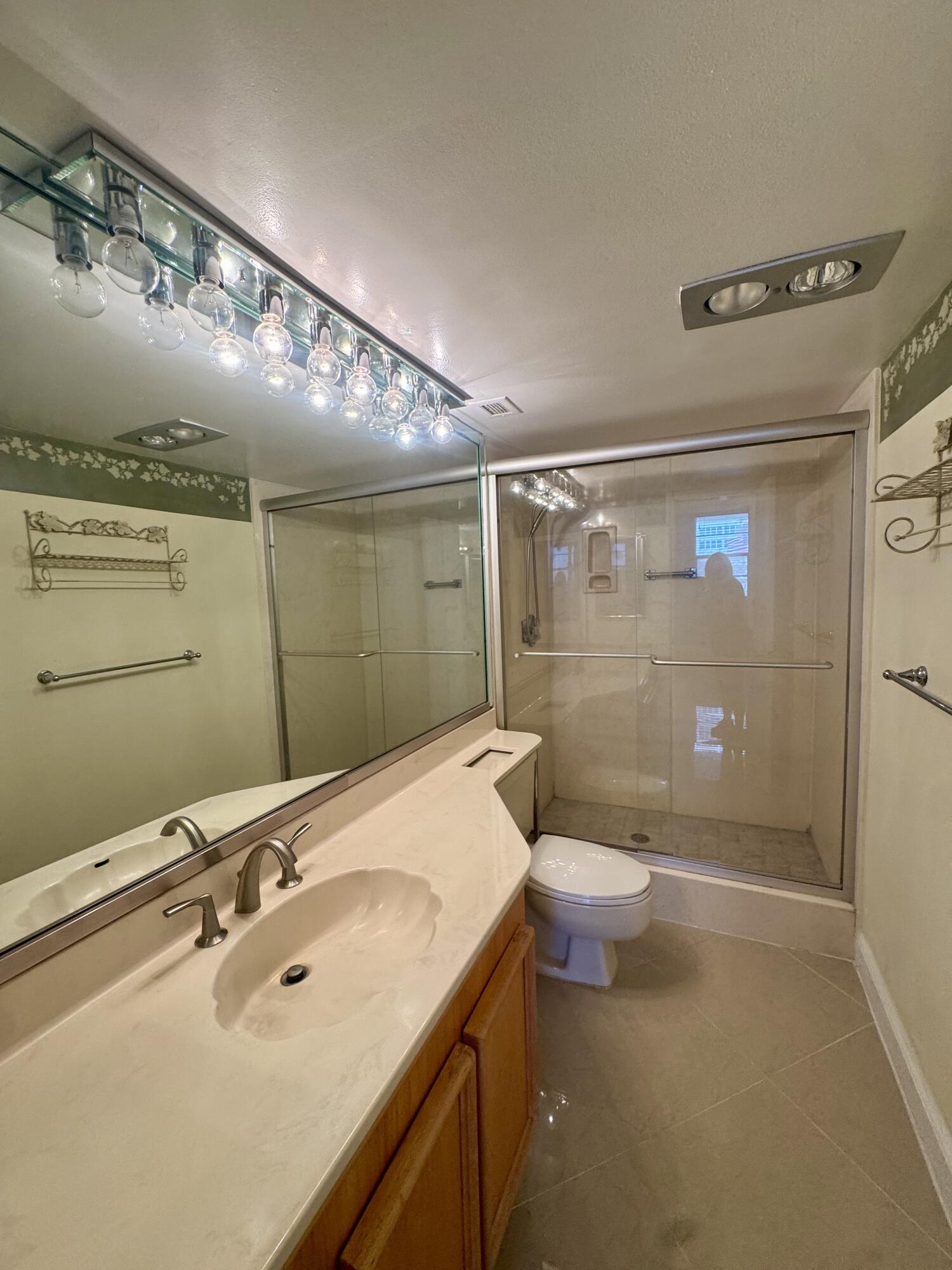 2851 South Ocean Boulevard, Unit 122 Boca Raton, FL 33432 - Photo 14 of 15 a bathroom with a sink a toilet and shower
