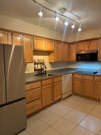 a kitchen with stainless steel appliances granite countertop a refrigerator and a sink