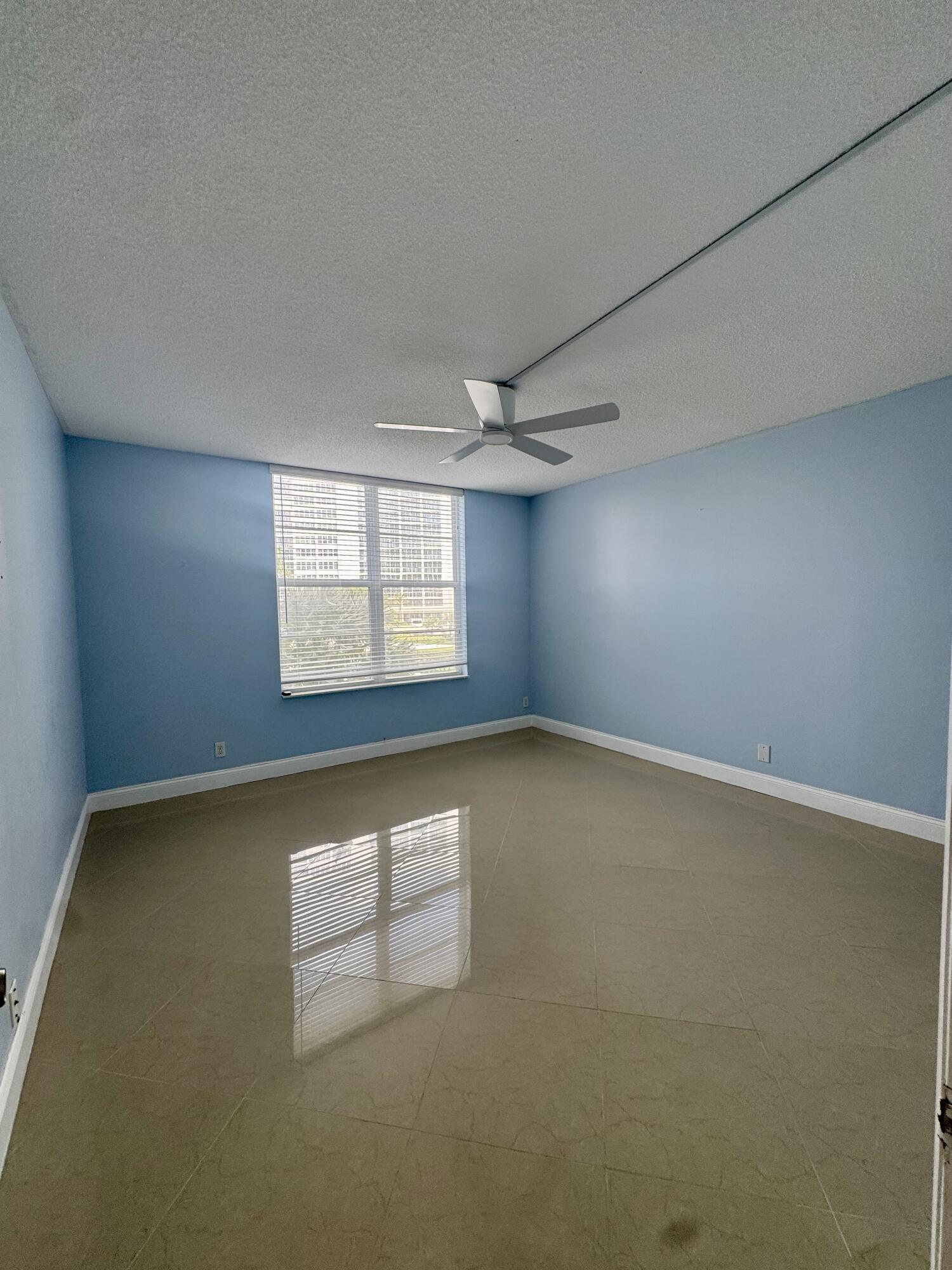 2851 South Ocean Boulevard, Unit 122 Boca Raton, FL 33432 - Photo 9 of 15 an empty room with windows