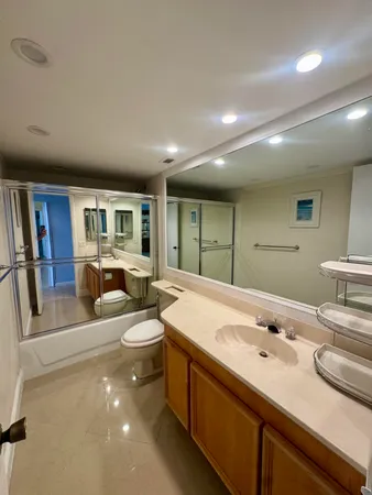 a spacious bathroom with a double vanity sink and a large mirror