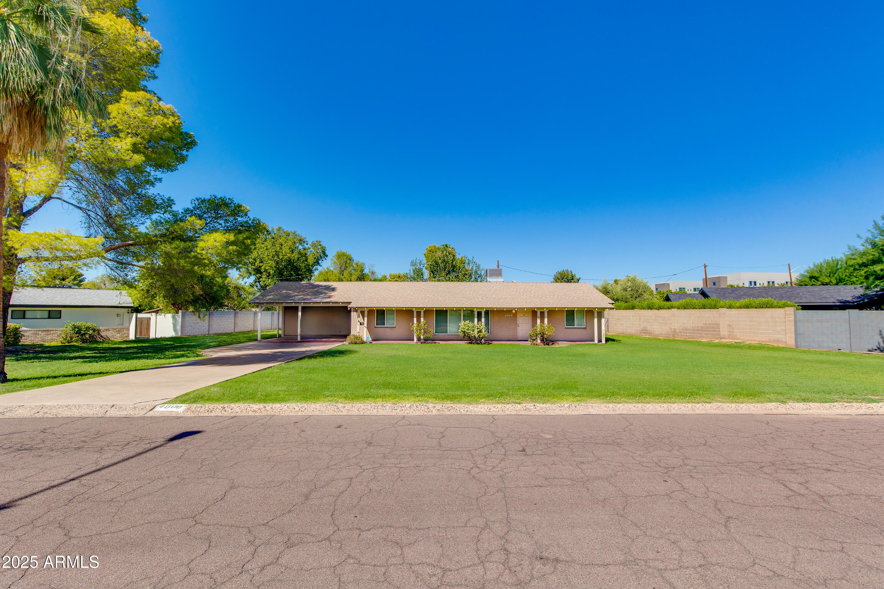 4808 North 29th Place Phoenix, AZ 85016 - Photo 1 of 18 a view of a house with a yard and large trees