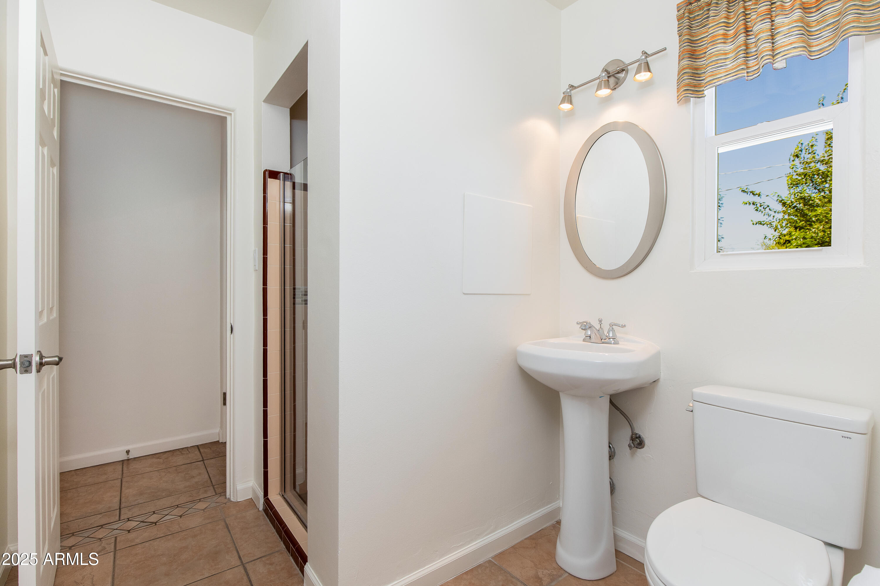 4808 North 29th Place Phoenix, AZ 85016 - Photo 11 of 18 a bathroom with a sink toilet and a mirror