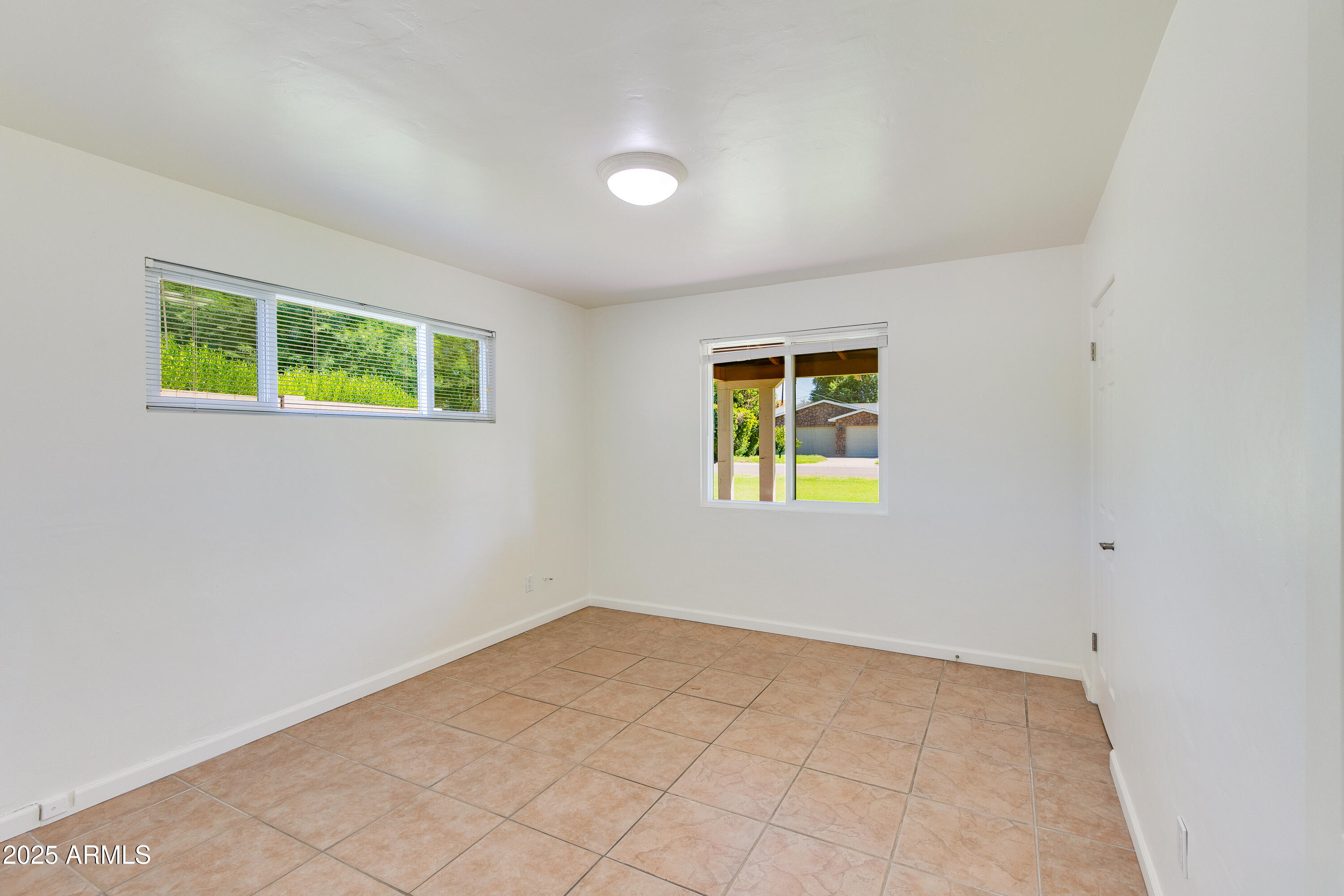 4808 North 29th Place Phoenix, AZ 85016 - Photo 12 of 18 an empty room with windows and plants