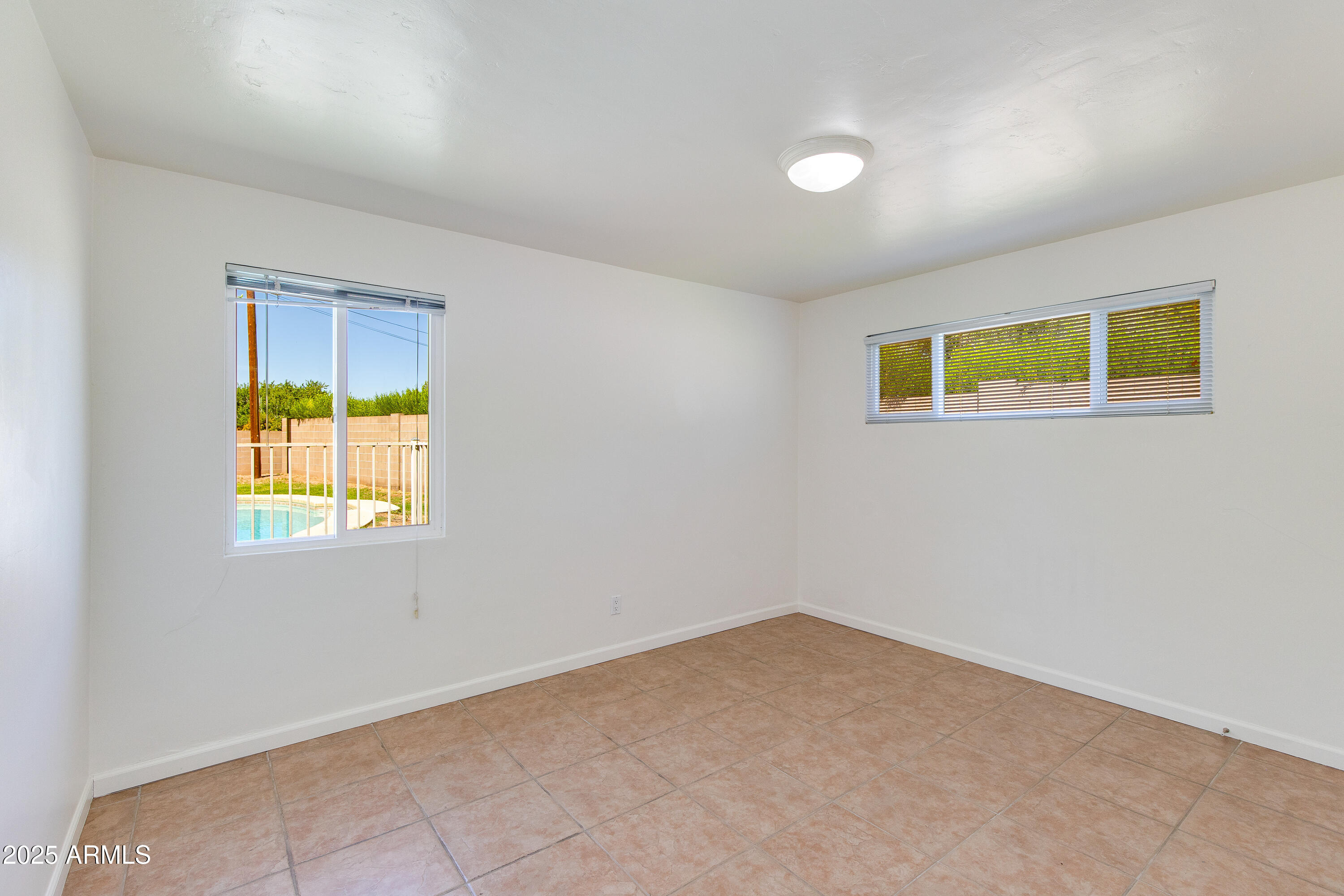 4808 North 29th Place Phoenix, AZ 85016 - Photo 14 of 18 an empty room with windows and dresser