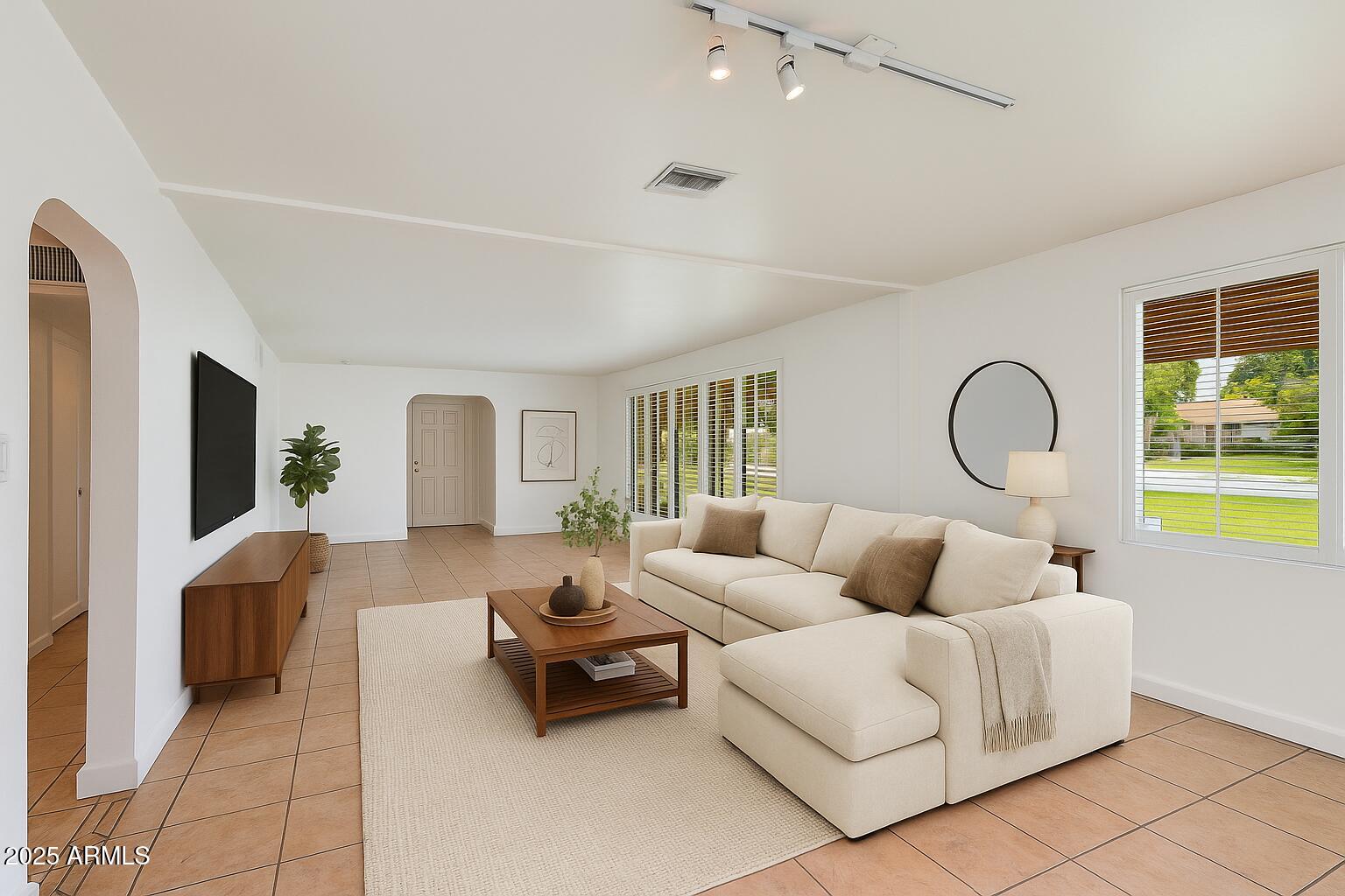 4808 North 29th Place Phoenix, AZ 85016 - Photo 2 of 18 a living room with furniture and a flat screen tv