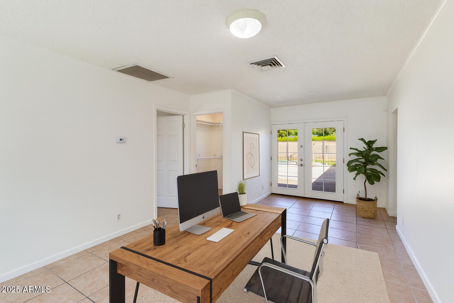 4808 North 29th Place Phoenix, AZ 85016 - Photo 5 of 18 a view of a workspace with furniture and a window