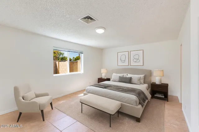 a bedroom with a bed and a couch