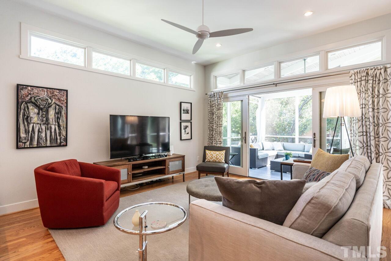 1210 Filmore Street Raleigh, NC 27605 - Photo 14 of 33 a living room with furniture a flat screen tv and a large window
