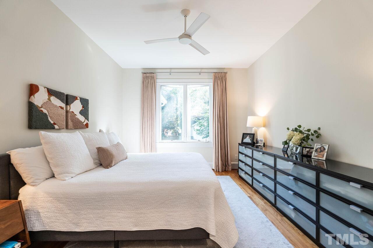 1210 Filmore Street Raleigh, NC 27605 - Photo 17 of 33 a bedroom with a bed and wooden floor