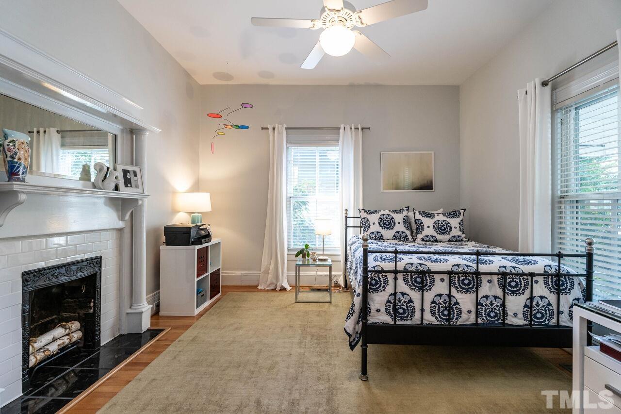 1210 Filmore Street Raleigh, NC 27605 - Photo 23 of 33 a bed room with furniture and a fireplace