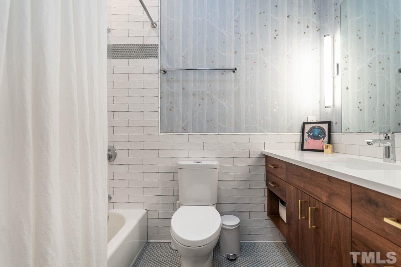1210 Filmore Street Raleigh, NC 27605 - Photo 25 of 33 a bathroom with a sink a toilet and shower
