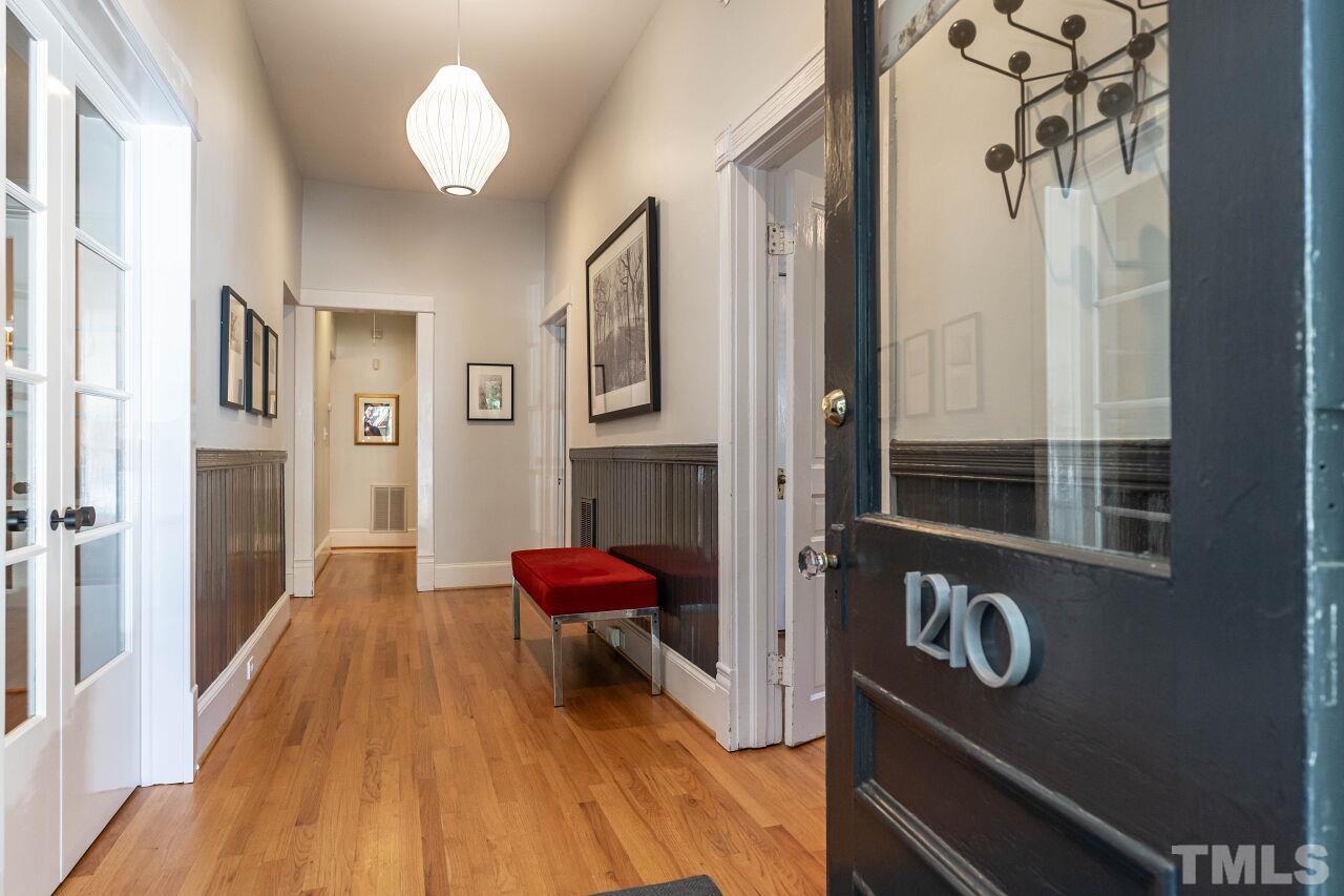 1210 Filmore Street Raleigh, NC 27605 - Photo 5 of 33 a view of a livingroom with furniture a dinning room and chandelier