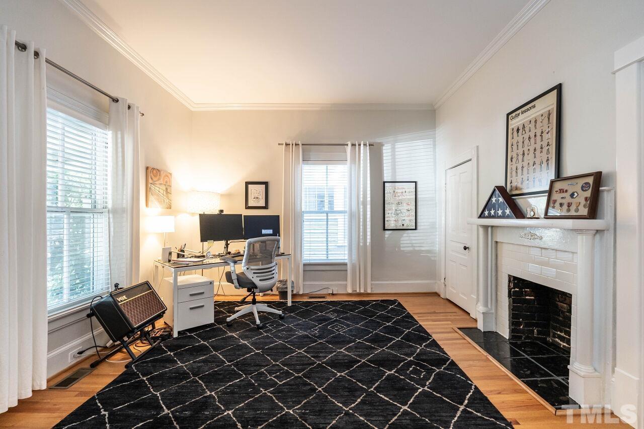 1210 Filmore Street Raleigh, NC 27605 - Photo 6 of 33 a living room with furniture a fireplace and a table