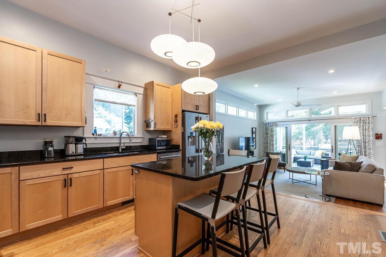 1210 Filmore Street Raleigh, NC 27605 - Photo 9 of 33 a kitchen with stainless steel appliances granite countertop a stove top oven a sink dishwasher and white cabinets with wooden floor