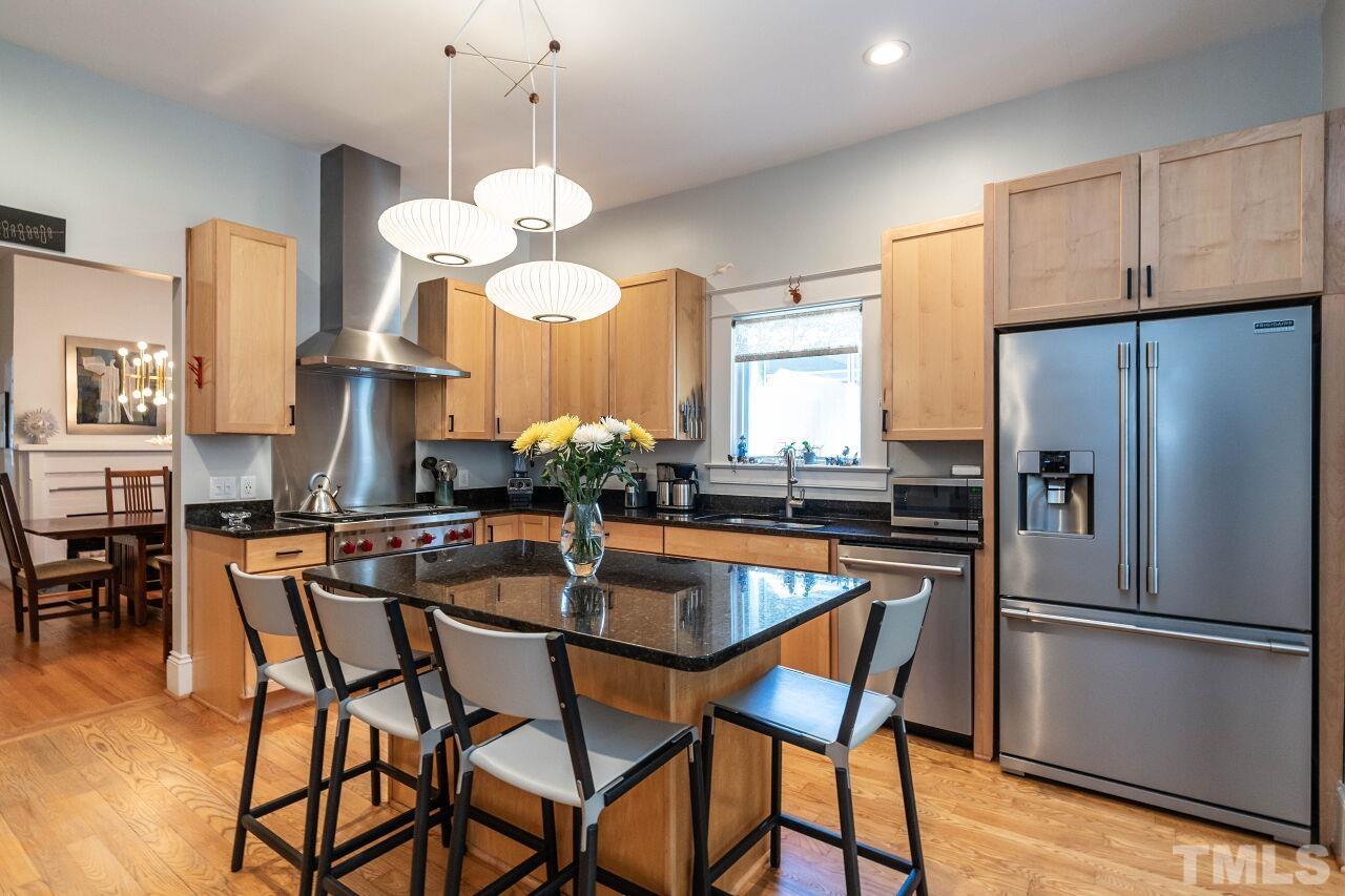 1210 Filmore Street Raleigh, NC 27605 - Photo 10 of 33 a kitchen with stainless steel appliances a dining table chairs and chandelier