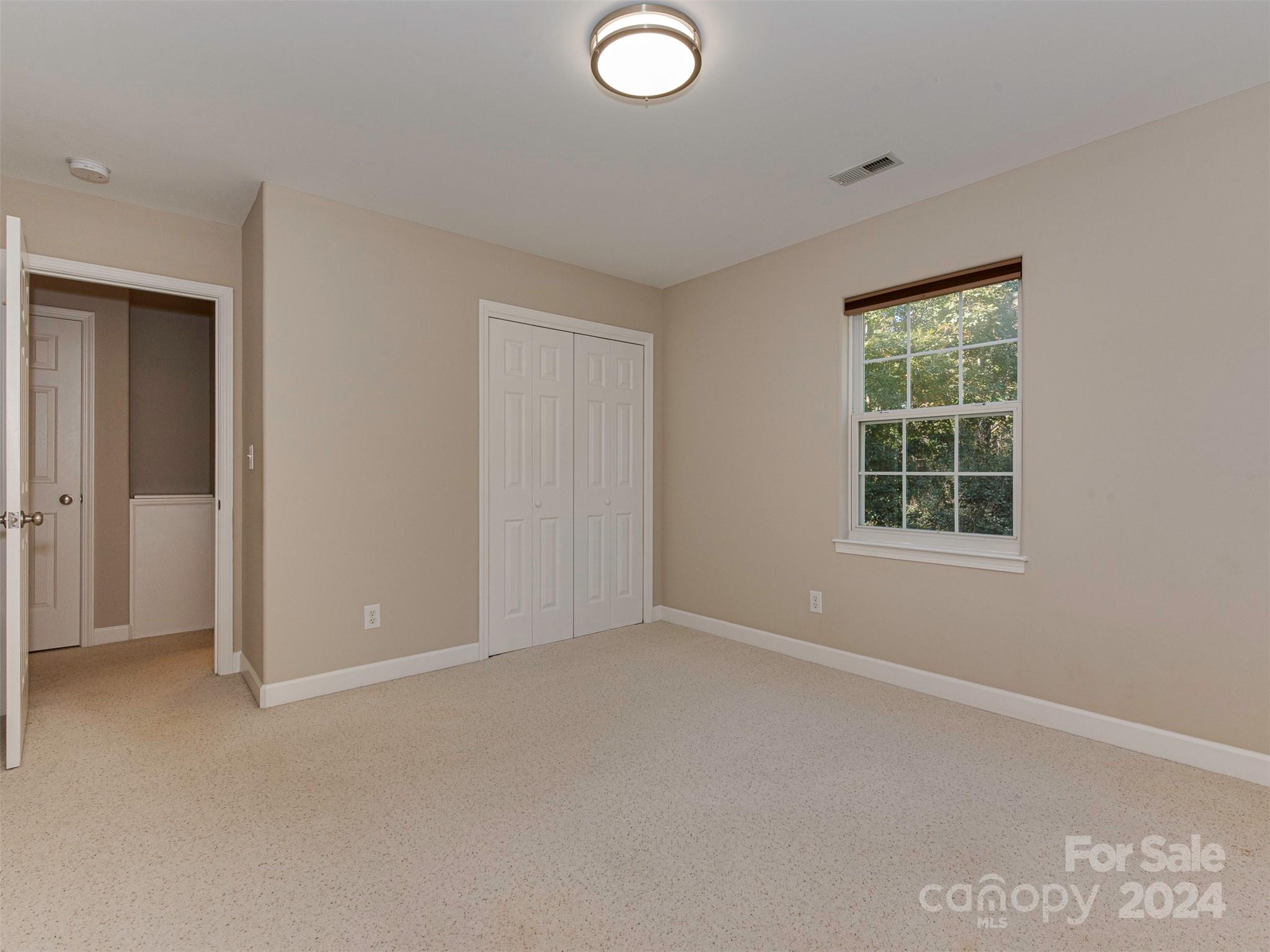 4801 Steepleton Way Charlotte, NC 28215 - Photo 18 of 28 an empty room with windows and closet