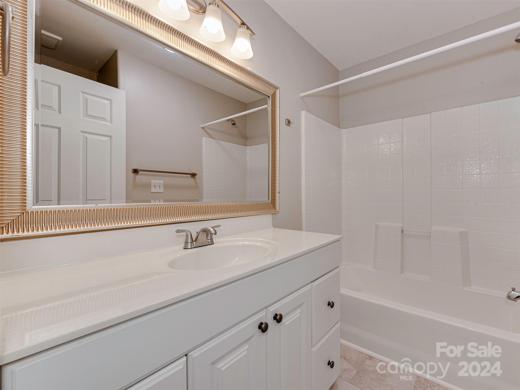 4801 Steepleton Way Charlotte, NC 28215 - Photo 19 of 28 a bathroom with a sink and a bathtub