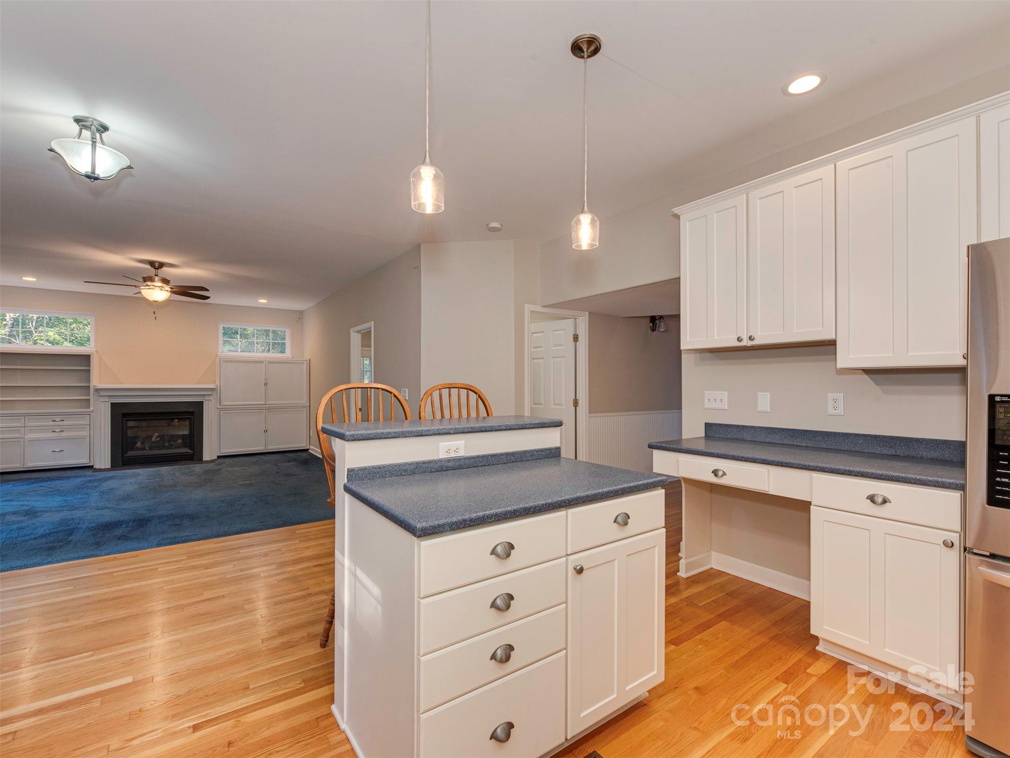 4801 Steepleton Way Charlotte, NC 28215 - Photo 2 of 28 a kitchen with granite countertop a stove a sink and white cabinets with wooden floor