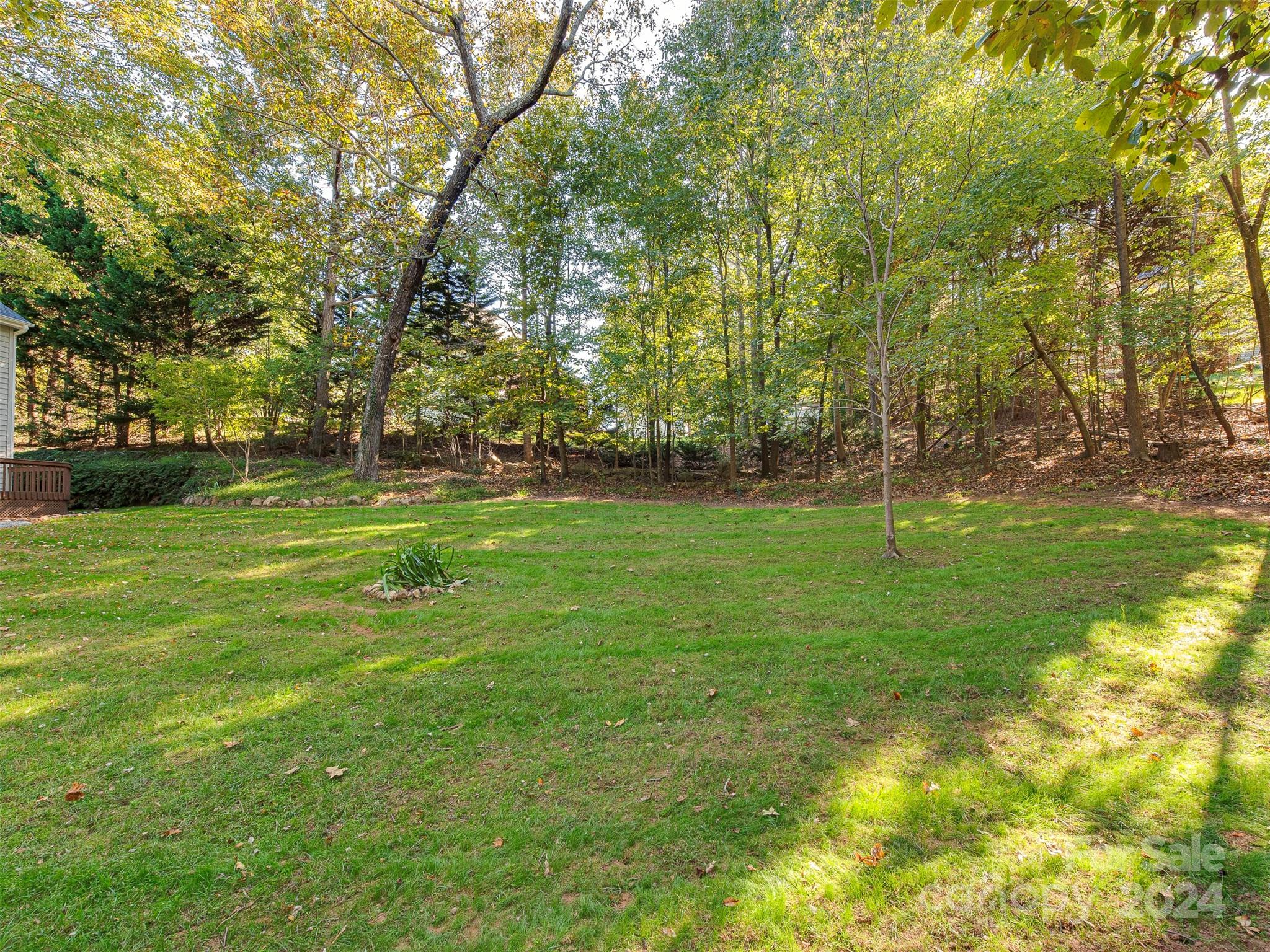 4801 Steepleton Way Charlotte, NC 28215 - Photo 24 of 28 a backyard of apartments with large trees