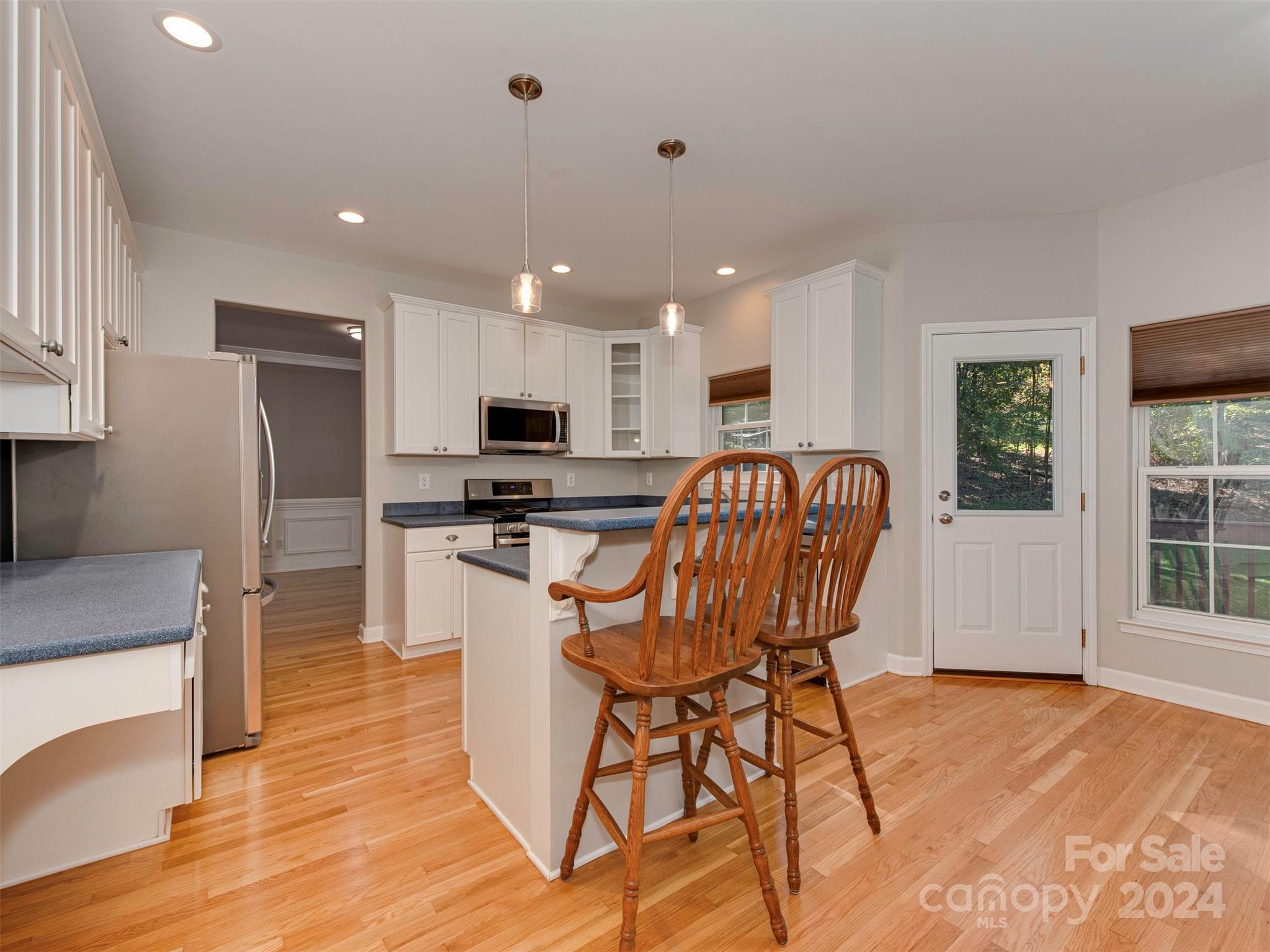 4801 Steepleton Way Charlotte, NC 28215 - Photo 3 of 28 a kitchen with stainless steel appliances granite countertop a refrigerator a stove top oven and a sink with granite countertops