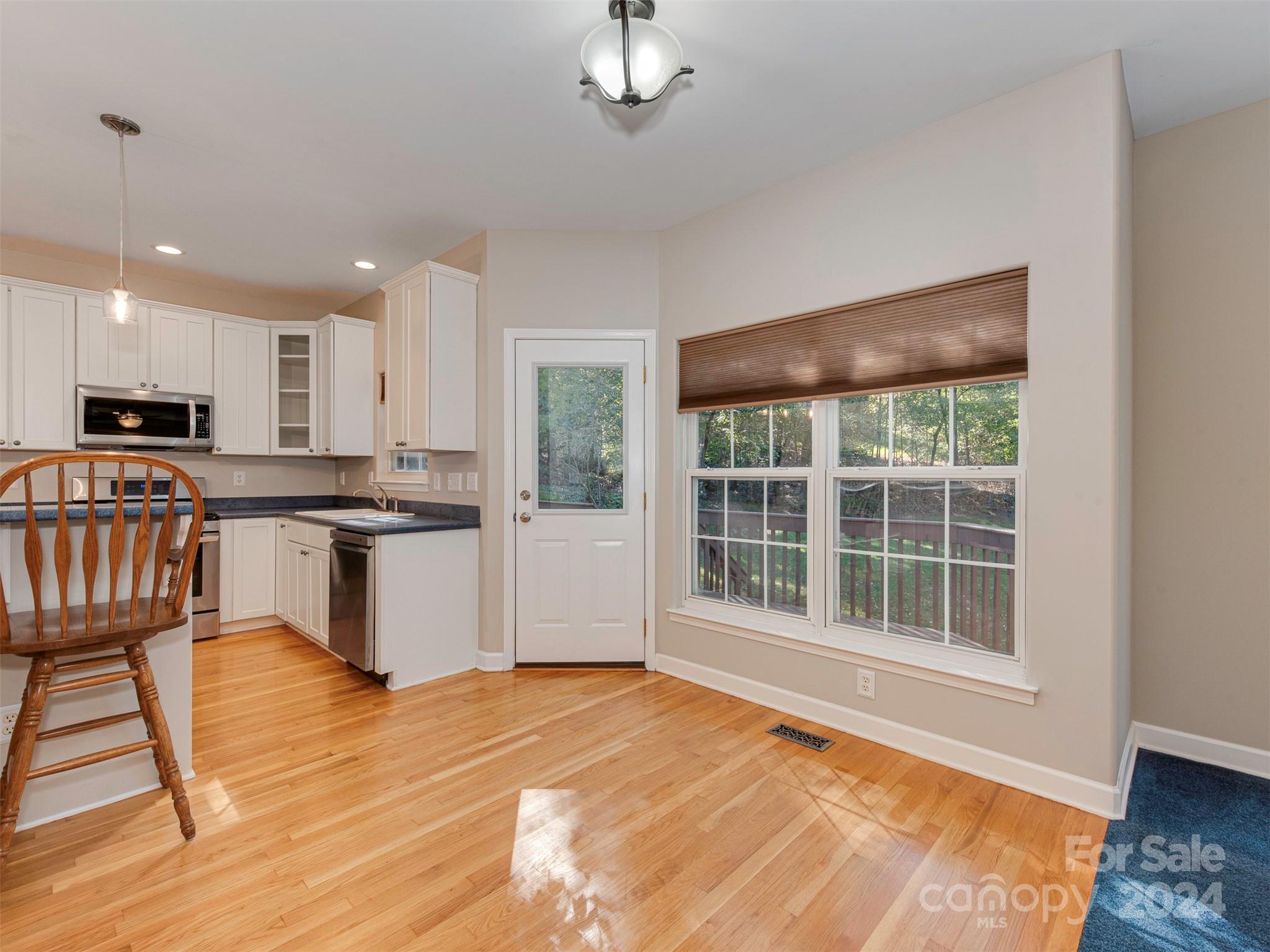 4801 Steepleton Way Charlotte, NC 28215 - Photo 4 of 28 a view of a kitchen with wooden floor and electronic appliances