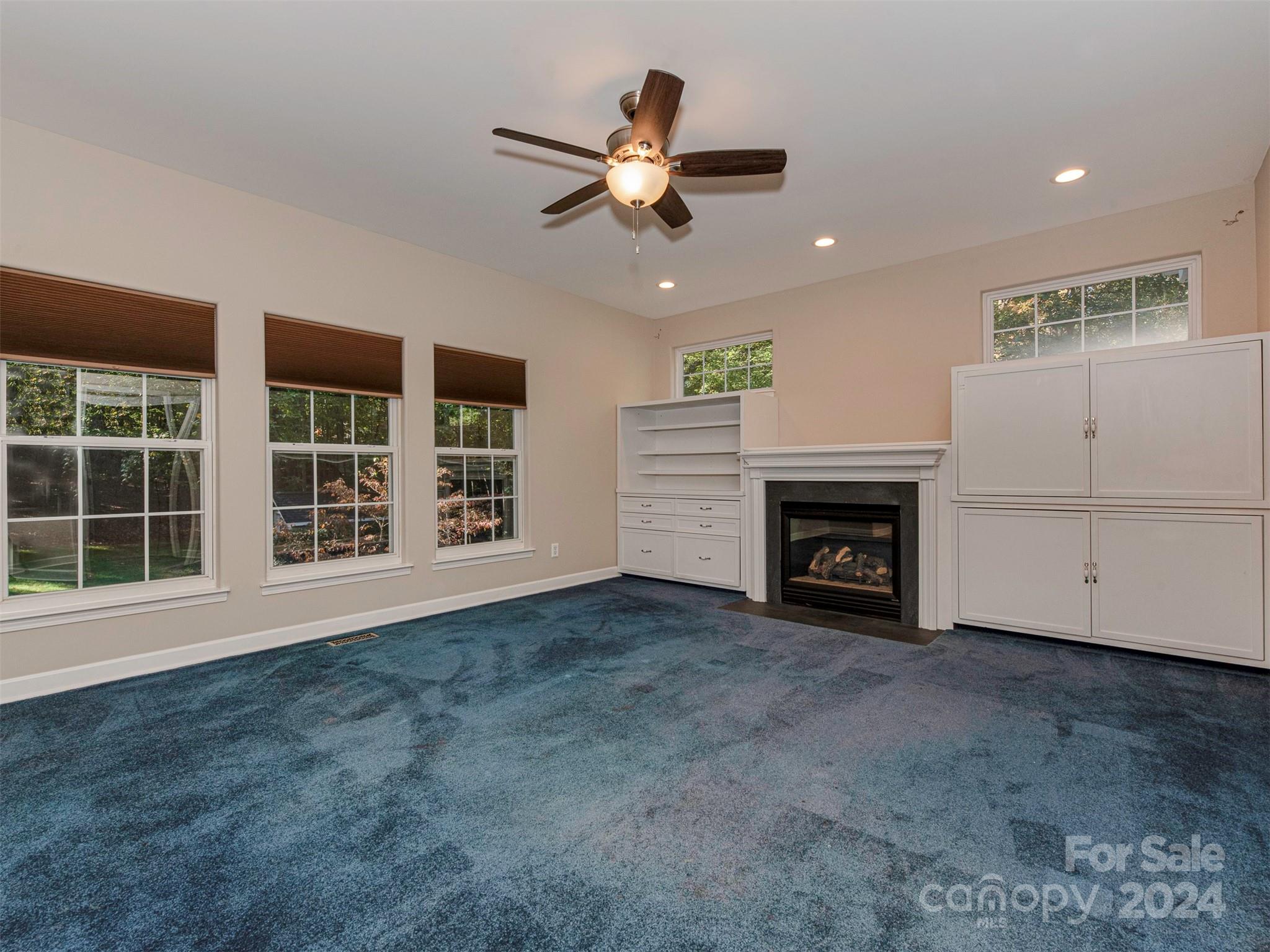 4801 Steepleton Way Charlotte, NC 28215 - Photo 5 of 28 a view of an empty room with a fireplace and a window