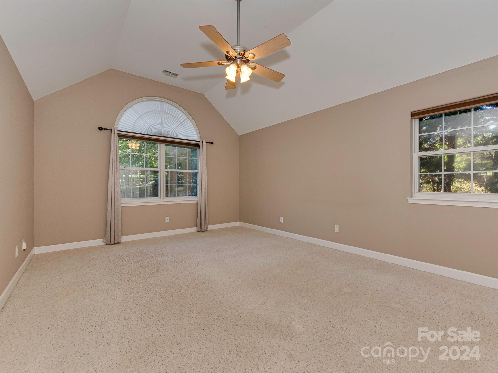 4801 Steepleton Way Charlotte, NC 28215 - Photo 9 of 28 an empty room with a window and a ceiling fan