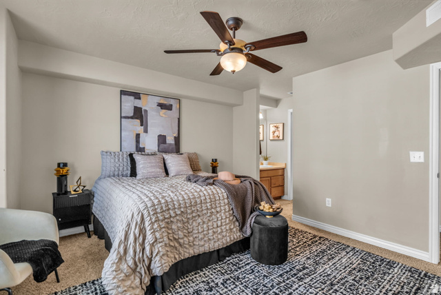 1136 West Spencer Road, Unit Y203 Pleasant Grove, UT 84062 - Photo 14 of 26 Carpeted bedroom with a ceiling fan, a textured ceiling, and ensuite bath