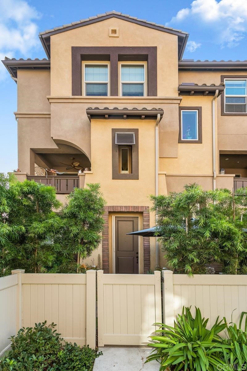 a front view of a house with plants