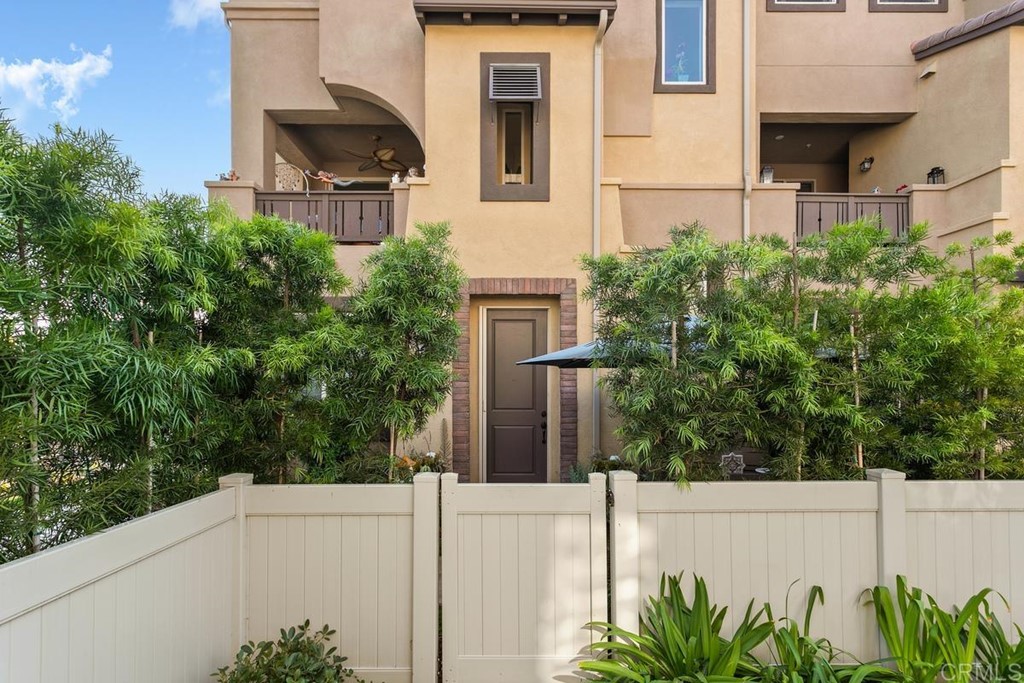 1267 Via Lucero Oceanside, CA 92056 - Photo 2 of 44 a view of a white house with large windows and plants